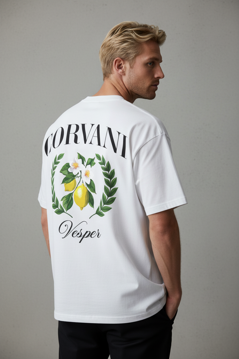 White Vita Al Mare Limone T-Shirt by CORVANI VESPER, casual cotton shirt with lemon print design, displayed on a hanger.